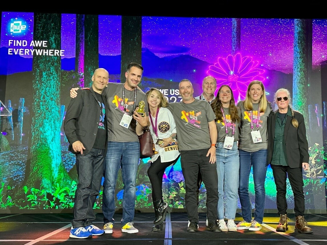 Maxar’s team accepts the Best Use of AI Auggie Award from AWE co-founders Ori Inbar (far left) and Tish Shute (far right) during the Augmented World Expo conference in early June. Image courtesy: Maxar.